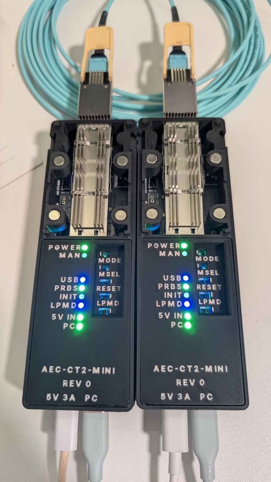 Two AEC-CT2-MINI rev 0 units in their home-printed cases